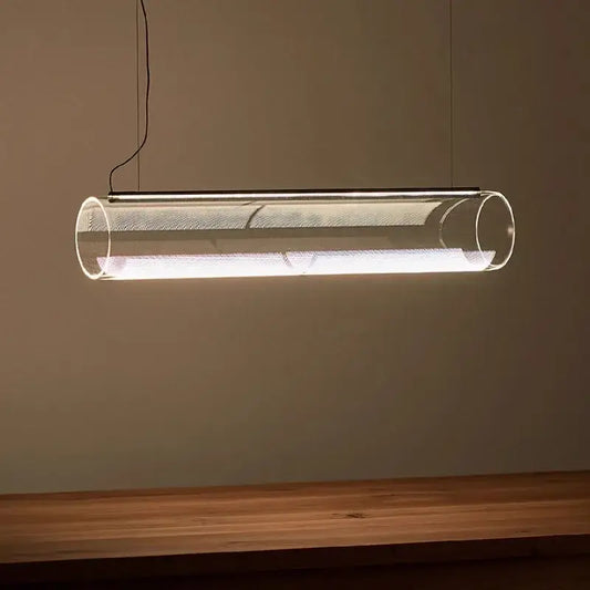 Modern clear glass cylinder chandelier pendant light with metallic mesh interior emitting warm white illumination