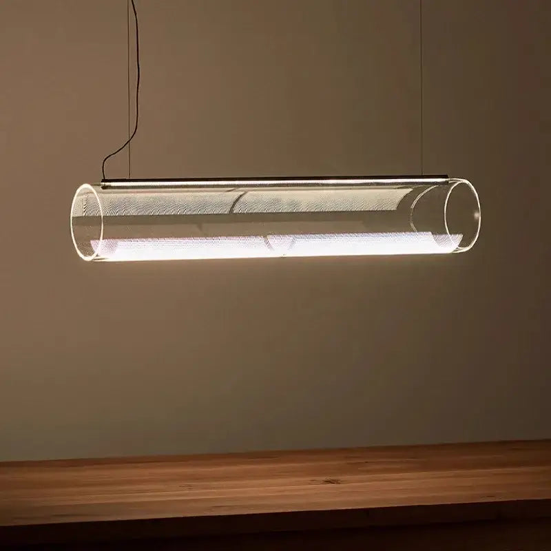 Modern clear glass cylinder chandelier pendant light with metallic mesh interior emitting warm white illumination