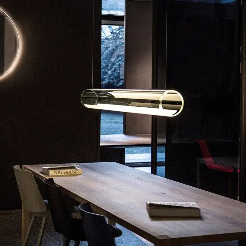 Modern clear glass cylinder pendant light with warm led glow for dining room featuring sleek minimalist design