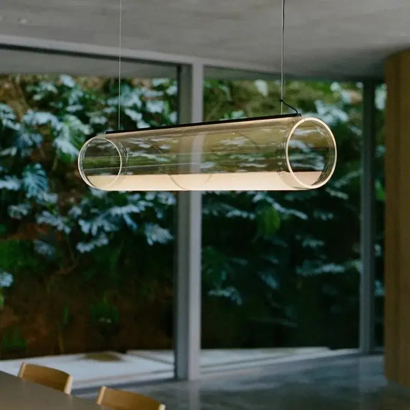 Modern clear glass cylinder pendant light with sleek design and warm led for dining room illumination