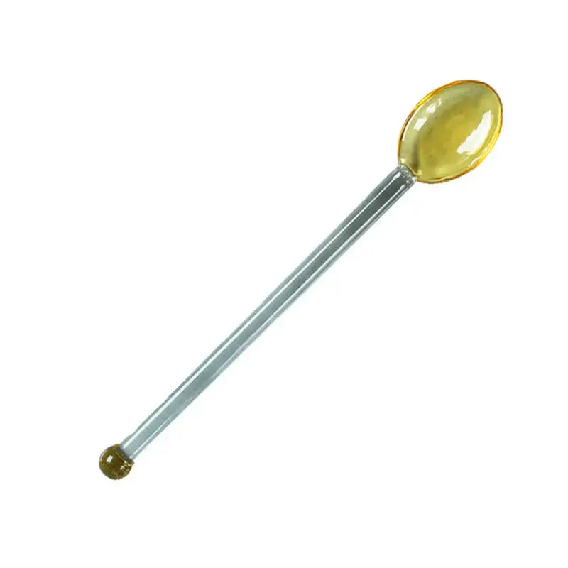 A translucent amber glass spoon with a polished metallic handle complements the modern glass dessert cup set
