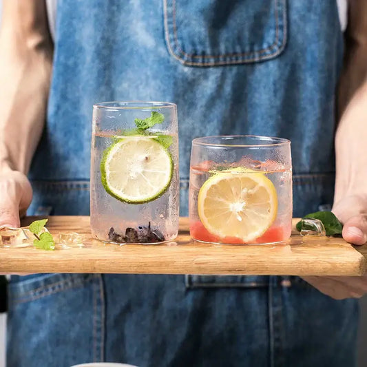 Modern clear glass drinkware cup set with two transparent tumblers featuring lime mint and lemon red fruit infusions