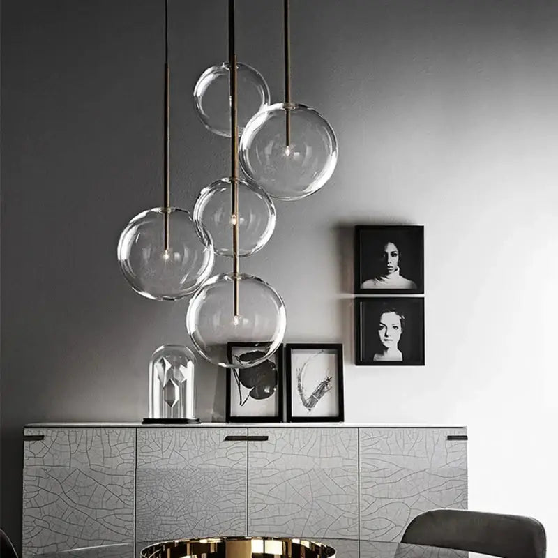 Modern pendant light with clear glass globe bulbs and gold metallic rods for kitchen rod suspension lighting