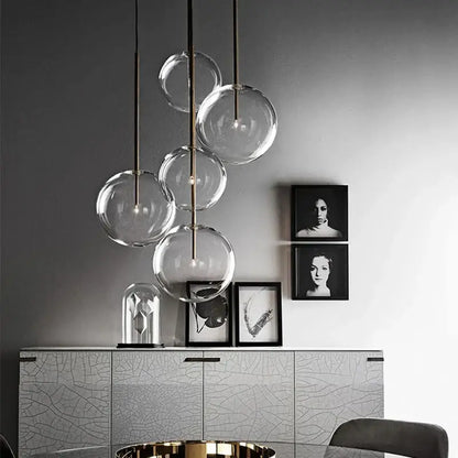 Modern pendant light with clear glass globe bulbs and gold metallic rods for kitchen rod suspension lighting