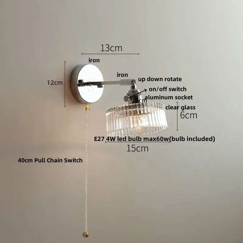 A sleek chrome wall lamp with a clear glass chandelier shade and adjustable arm for modern bedroom decorbites clear glass