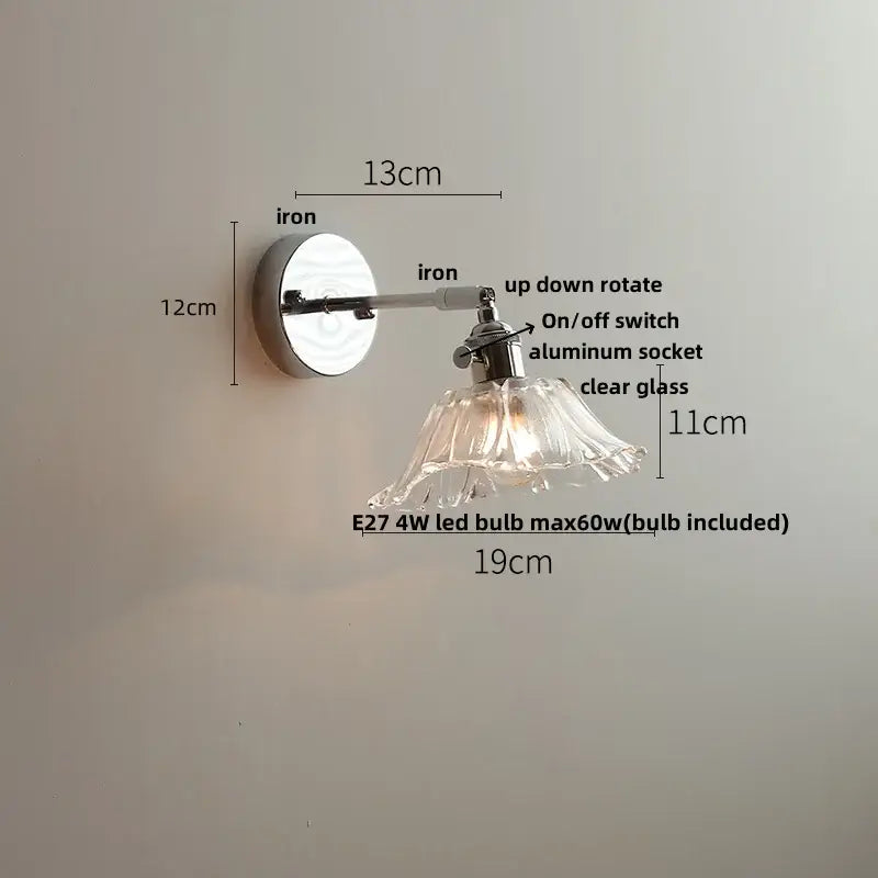 A modern wall lamp with polished iron arm and decorbites clear glass shade for bedroom led pull chain lighting