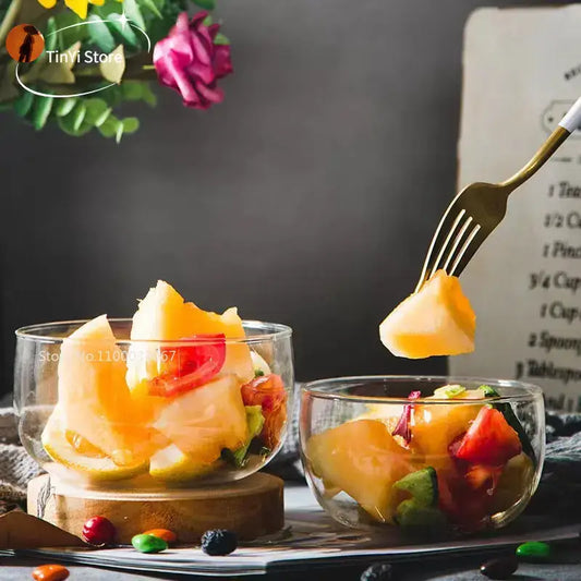 Modern clear glass salad bowl set featuring a transparent glass salad bowl with colorful fresh fruit chunks