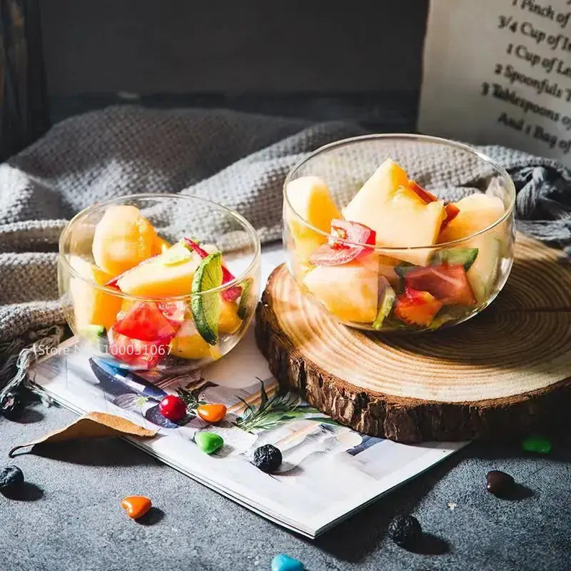Modern clear glass salad bowl set featuring two transparent glass salad bowls filled with colorful fruit salad