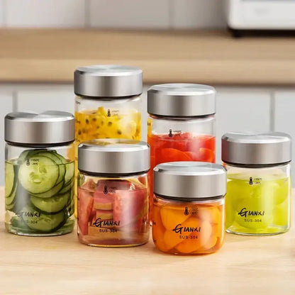 Modern clear glass sealed jug kitchen storage jars with stainless steel lids labeled gianxi sus-304 filled with sliced vegetables