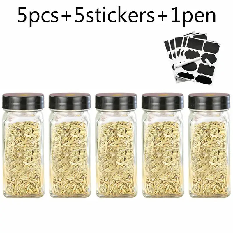 Modern clear glass seasoning jar set with five glass seasoning jars filled with fennel seeds and black lids for kitchen use