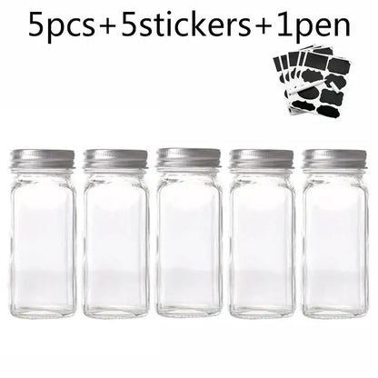 Modern clear glass seasoning jar set featuring five clear glass seasoning jars with silver metal lids for kitchen use
