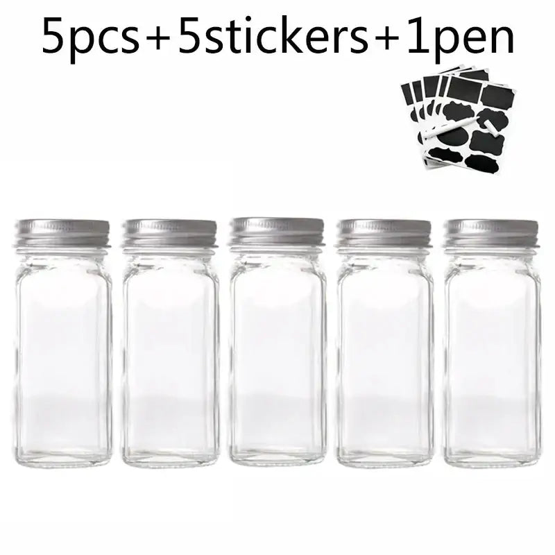 Modern clear glass seasoning jar set featuring five clear glass seasoning jars with silver metal lids for kitchen use