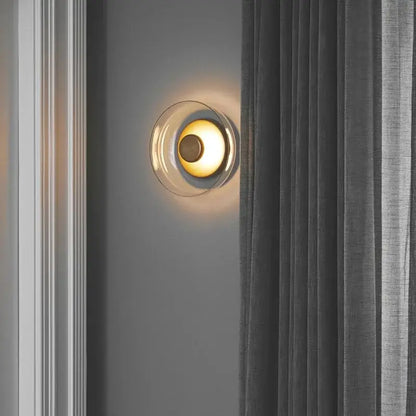 Modern clear glass table lamp with circular translucent shade and warm golden light for bedroom decorbites clear glass