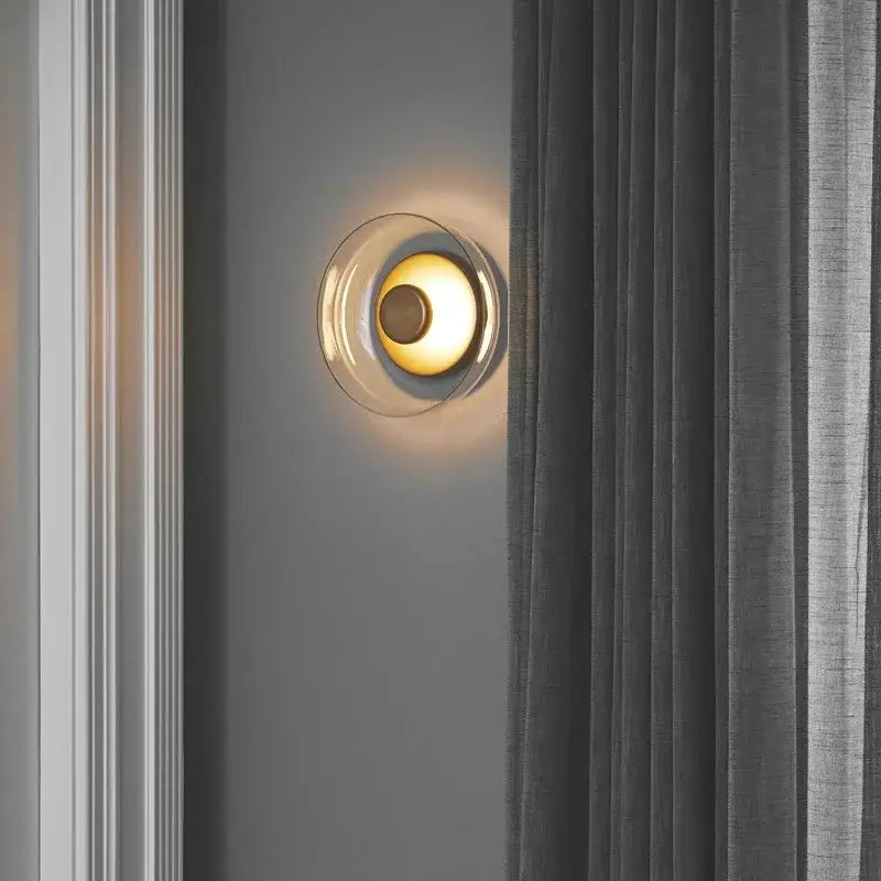 Modern clear glass table lamp with circular translucent shade and warm golden light for bedroom decorbites clear glass