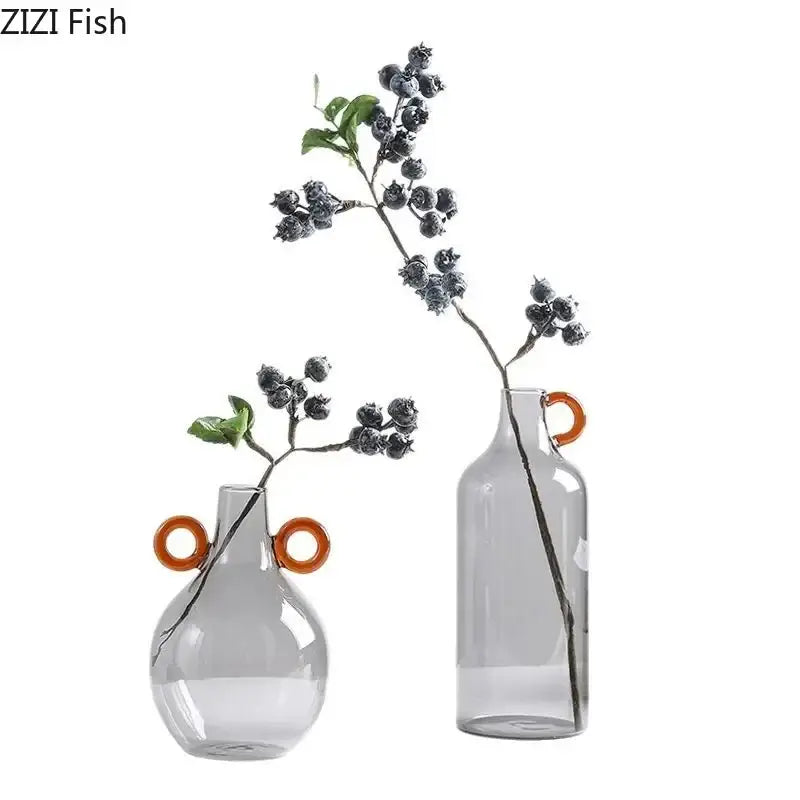 Two translucent gray clear glass vases with orange circular handles modern clear glass vase decor for living room