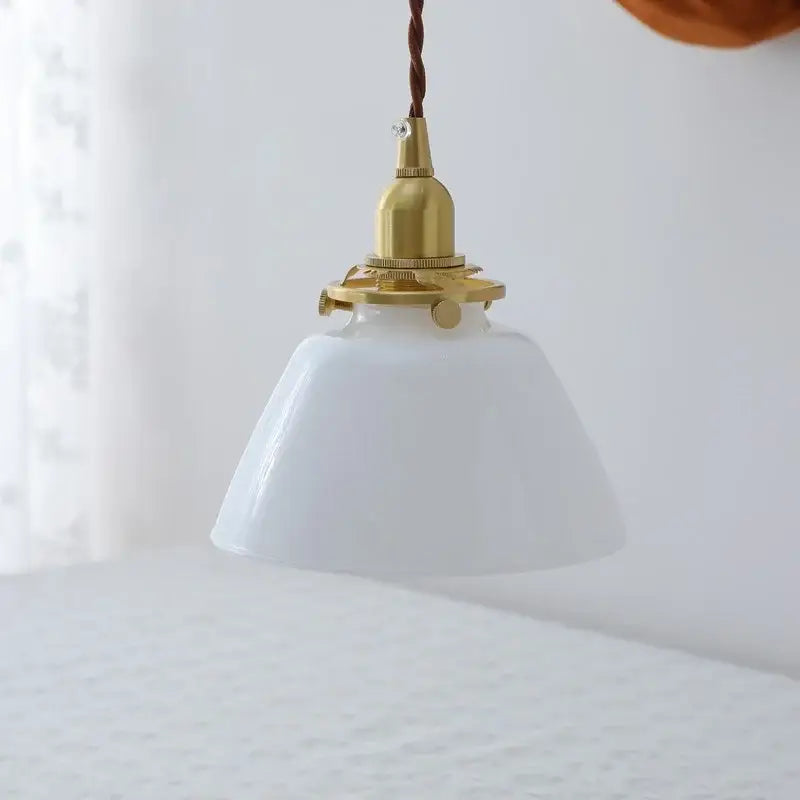 Modern clear glass led pendant lamp with white ceramic shade brass fixture and twisted brown cord for kitchen light