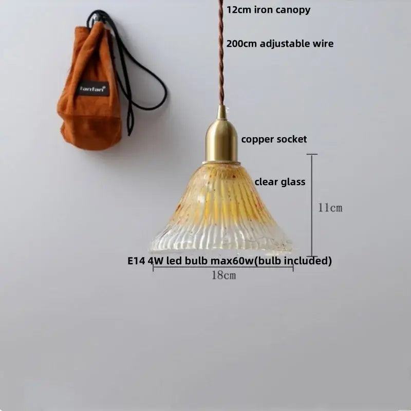 Modern clear glass and white ceramic led pendant lamp featuring a bell-shaped glass led pendant with amber streaks and copper socket