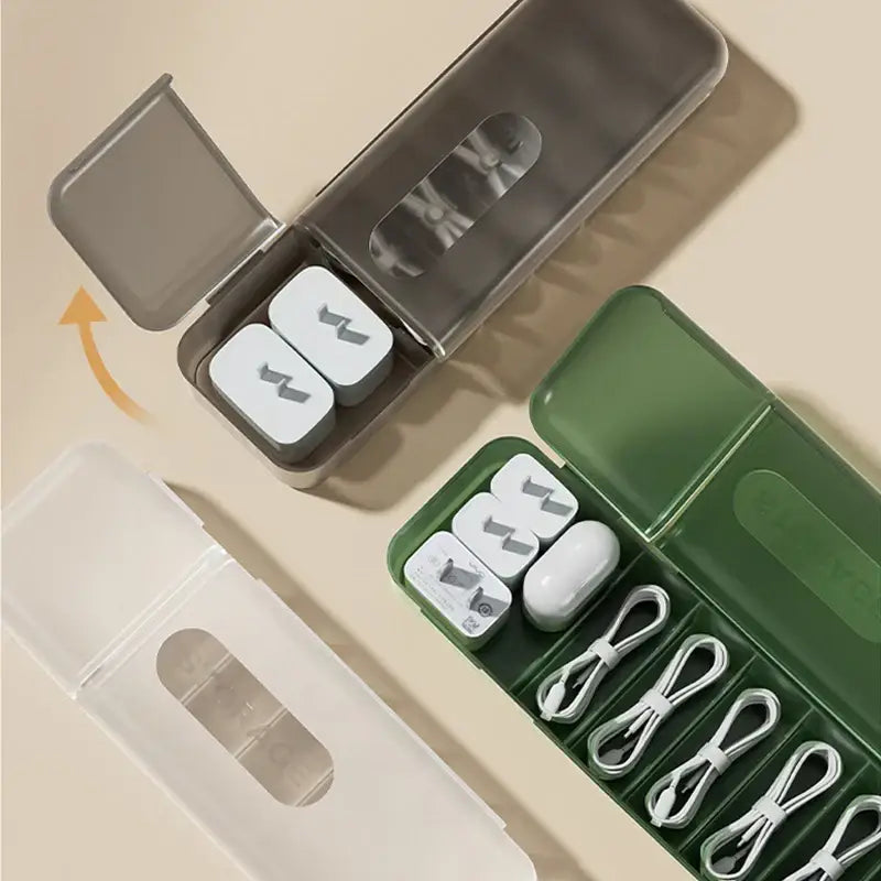 Transparent plastic decorbites cable box with gray lid and clear window holding white lightning-shaped wireless chargers