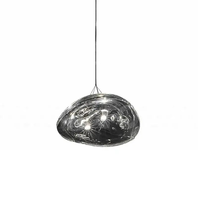 A sleek dark gray glass staircase pendant light with smooth organic shape and swirling internal patterns for dining room