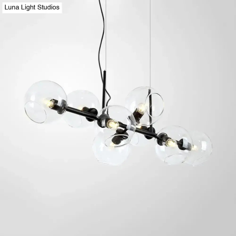 Modern black metal lighting fixture with clear smoke glass spheres and exposed bulbs for dining room use