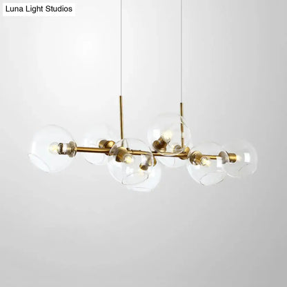 Modern clear smoke glass lighting fixture with brass and black accents featuring eight spherical bulbs for dining room