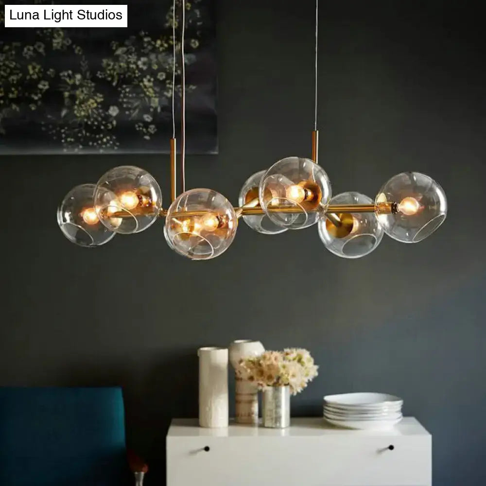 Modern black and gold lighting fixture with clear smoke glass globe shades and eight bulbs for dining room use