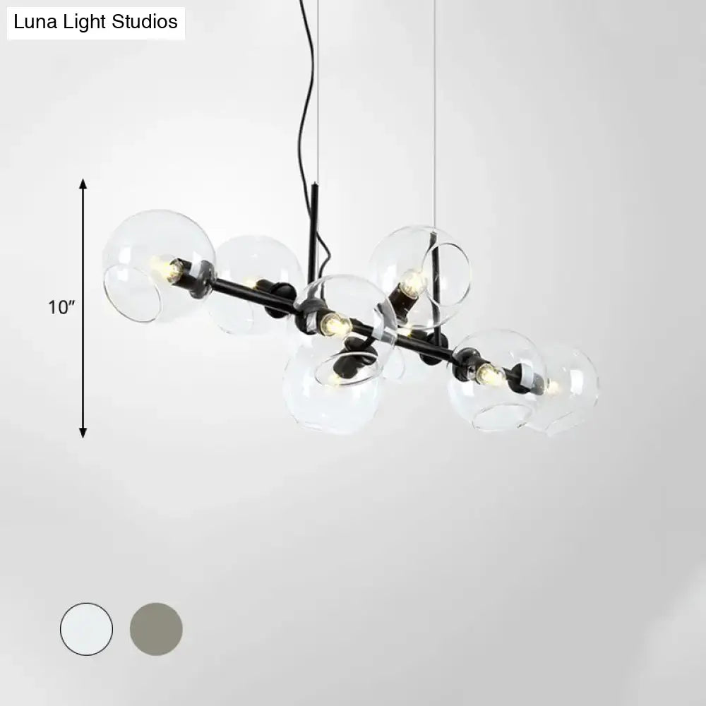 Modern black and gold lighting fixture with clear smoke glass globe bulbs designed for dining room use