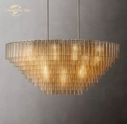 Modern clear smoke glass oval chandelier featuring golden tiered design with cascading panels for dining room decorbites clear smoke