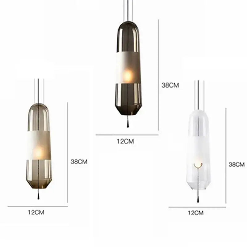 Modern clear and smoked glass pendant lights with cylindrical shades and metallic bands for dining room use