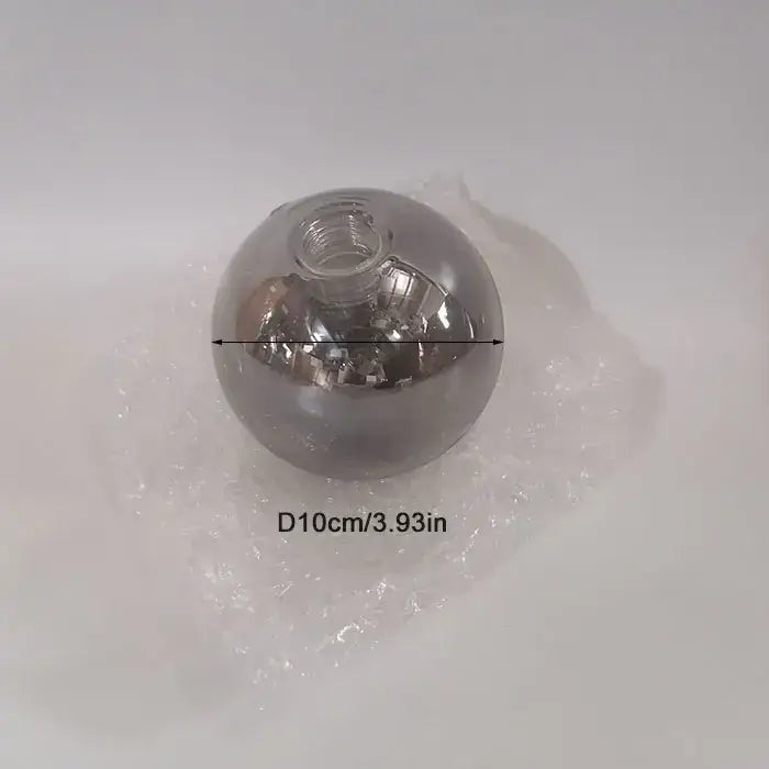A sleek transparent glass shade replacement with metallic silver finish and threaded neck for living room globe