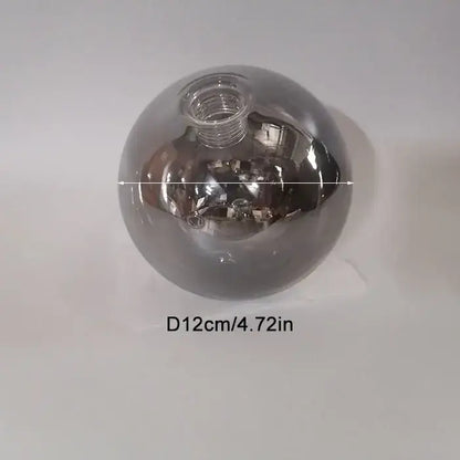 A sleek 12cm diameter spherical glass shade replacement with metallic silver finish and threaded neck for living room globe