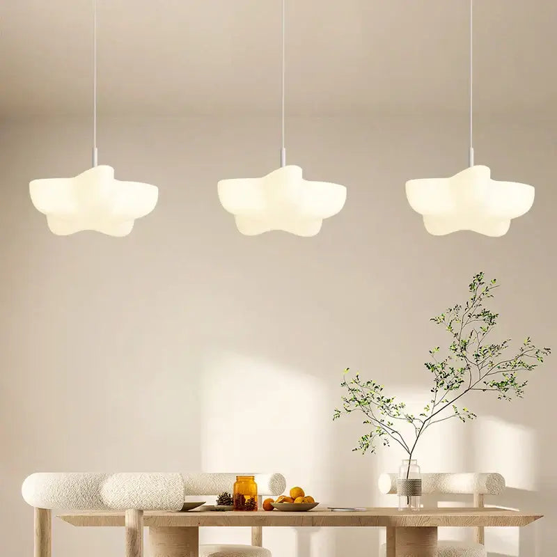 Three off-white cloud white floating pendant lights with matte finish hang above wooden dining table decorbites cloud white