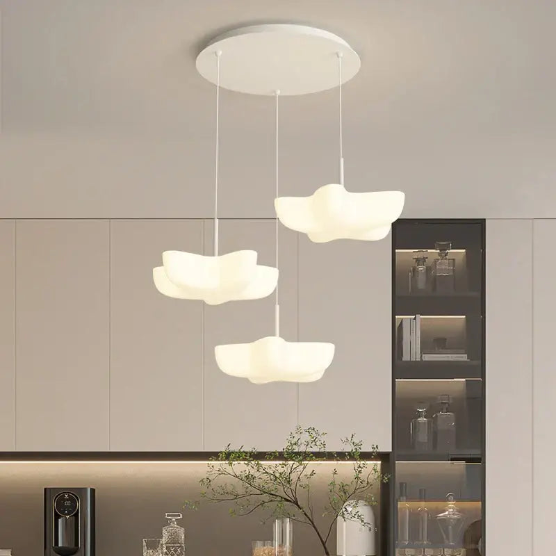 Three white cloud white floating pendant lights hanging from a circular fixture for dining room decorbites pendant light