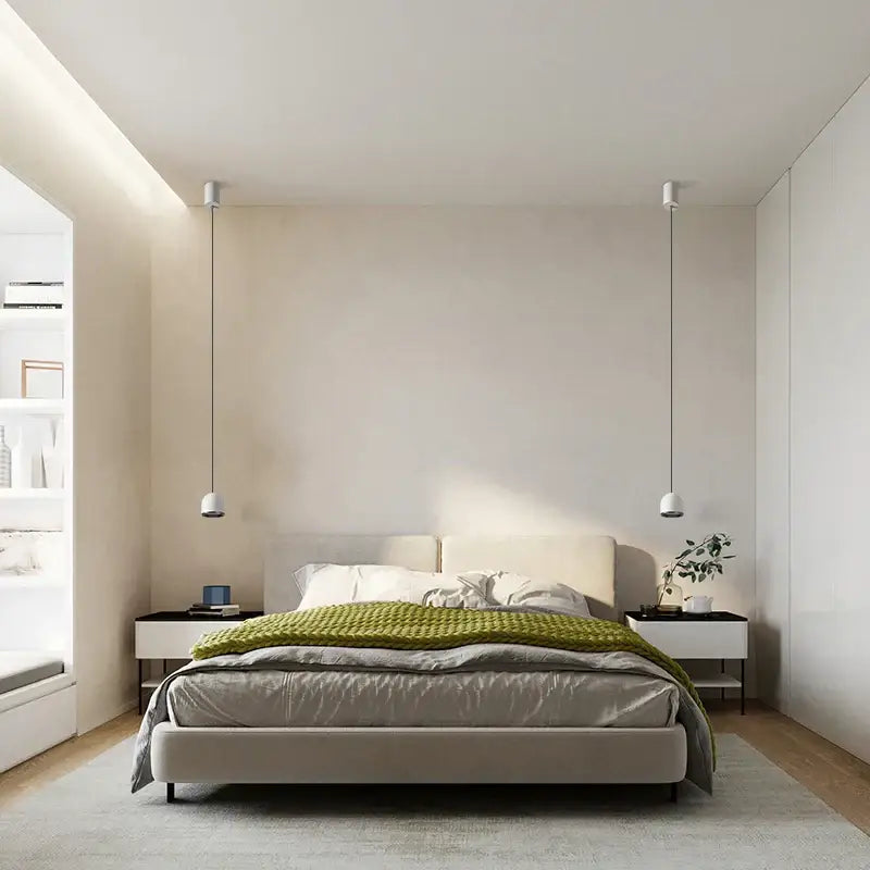 Modern beige upholstered bed with gray duvet and olive green throw beside decorbites cob pendant light chandelier