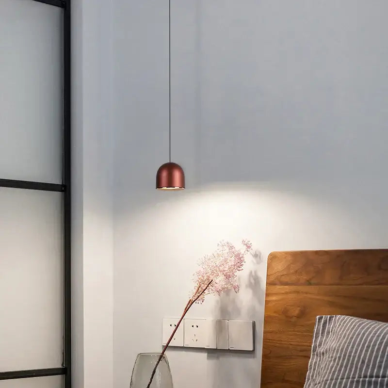 Copper-colored decorbites cob pendant light with sleek minimalist design hanging from thin black cord for dining room decor