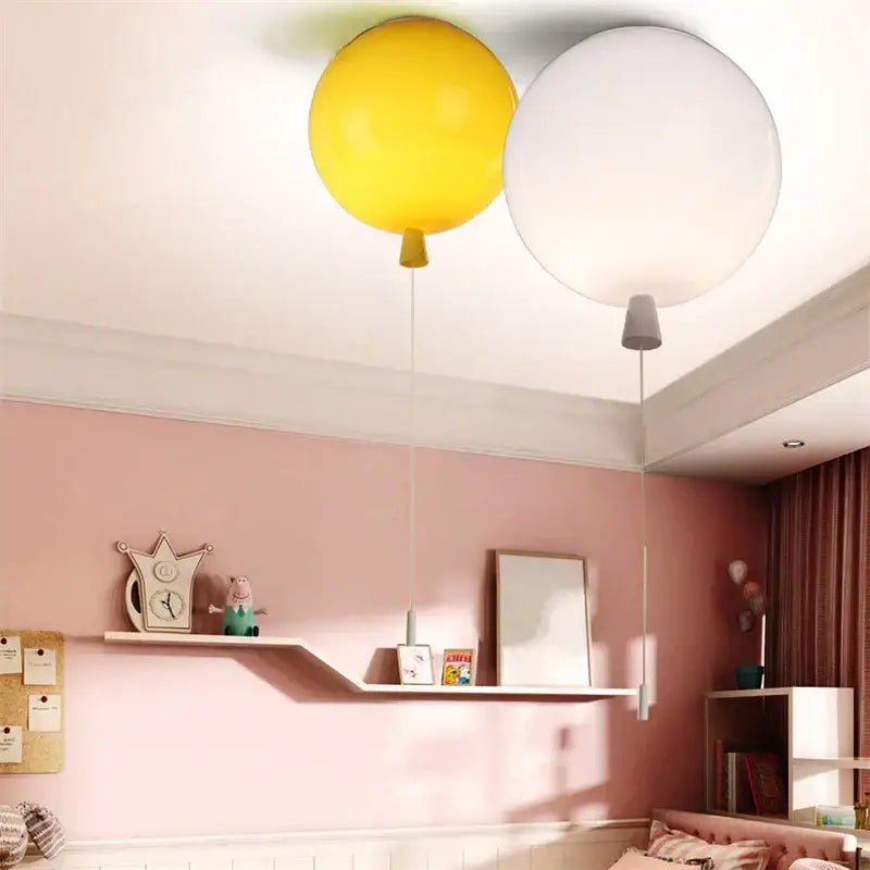 Two balloon acrylic ceiling lights in bright yellow and white with cords designed for kids bedroom ceiling light