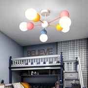 A modern colorful cartoon led chandelier light with white pink yellow and blue spherical bulbs for kids bedroom