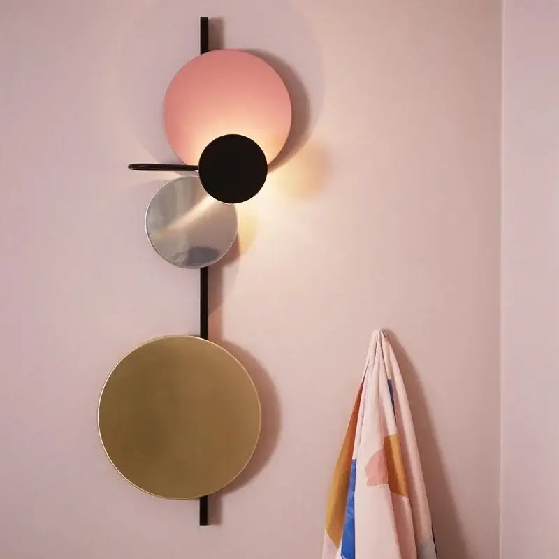 Modern colorful circle metal wall lamp with stacked circular shades in matte pink black mirrored silver and gold for decorbites