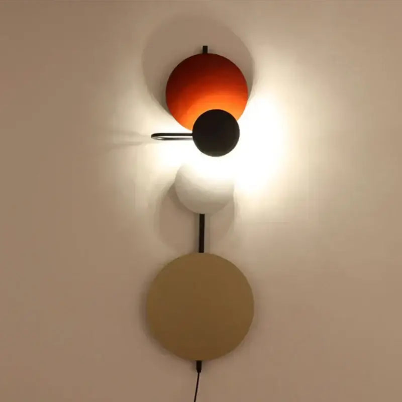 Modern colorful circle metal wall lamp with vibrant orange, matte black, white, and beige spherical shades for bedroom decorbites decor