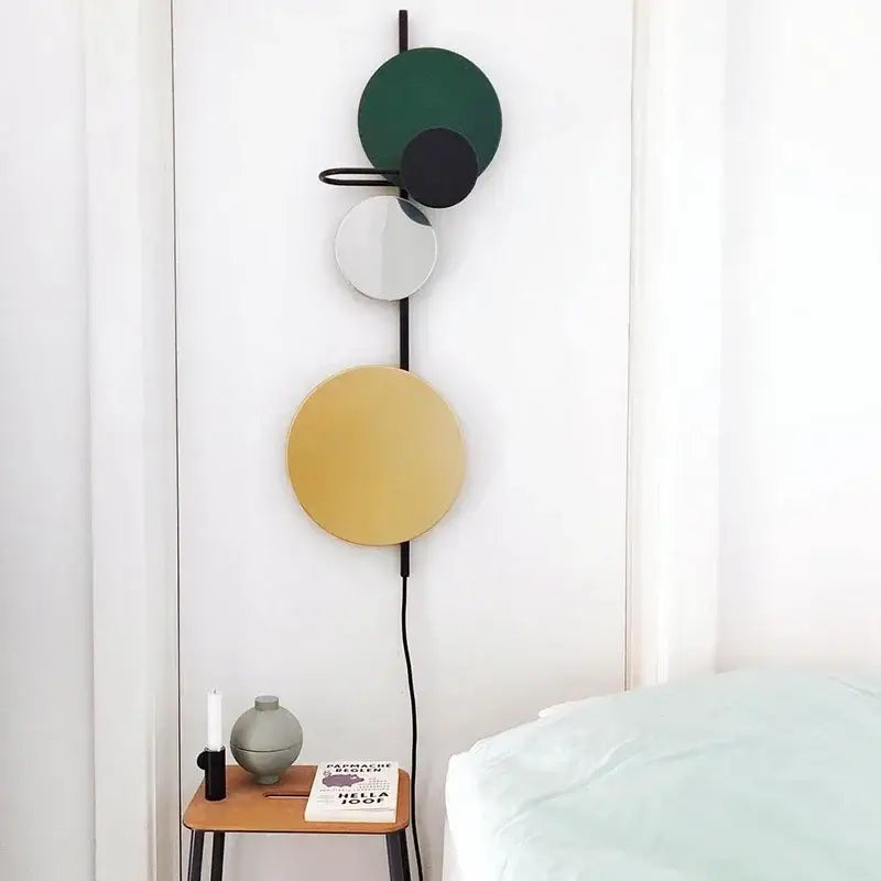 Modern colorful circle metal wall lamp with stacked green black and gold discs on black frame for bedroom decorbites wall lamp
