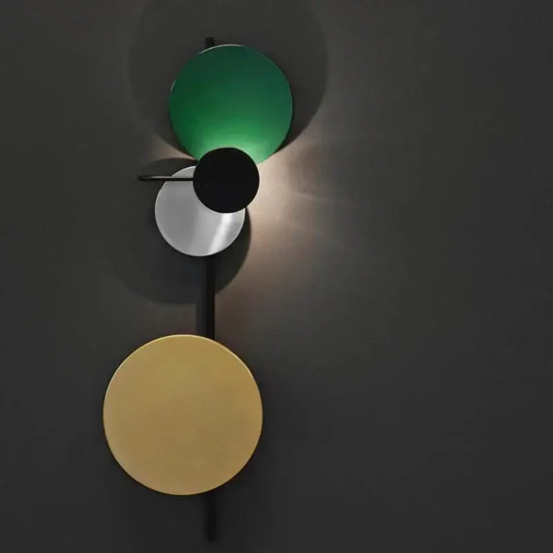 Modern colorful circle metal wall lamp with emerald green, matte black, brushed silver, and gold-toned shades decorbites colorful circle