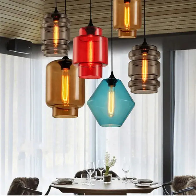A collection of decorbites geometric glass pendant lights with colorful red amber and teal shades for kitchen lighting