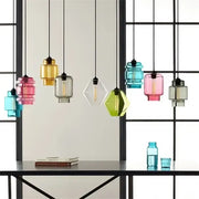 Modern colorful geometric glass pendant lights with exposed filament bulbs and black cords for kitchen lighting decorbites geometric glass