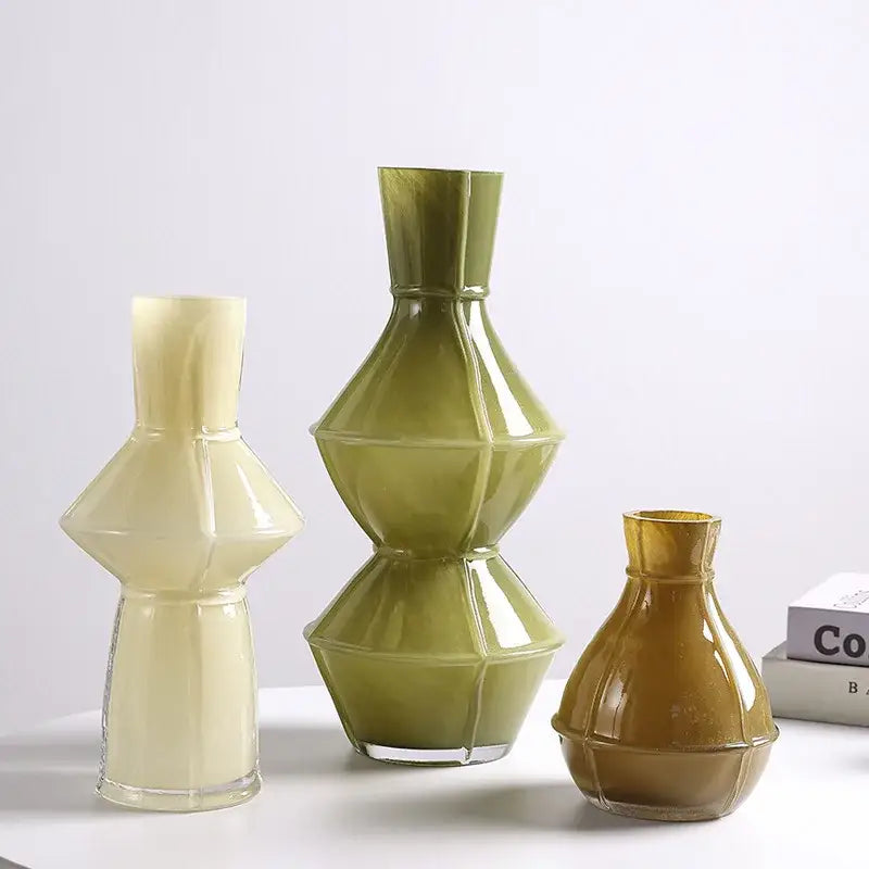 Three colorful geometric glass vases in cream olive green and amber with faceted designs for modern decorbites decor
