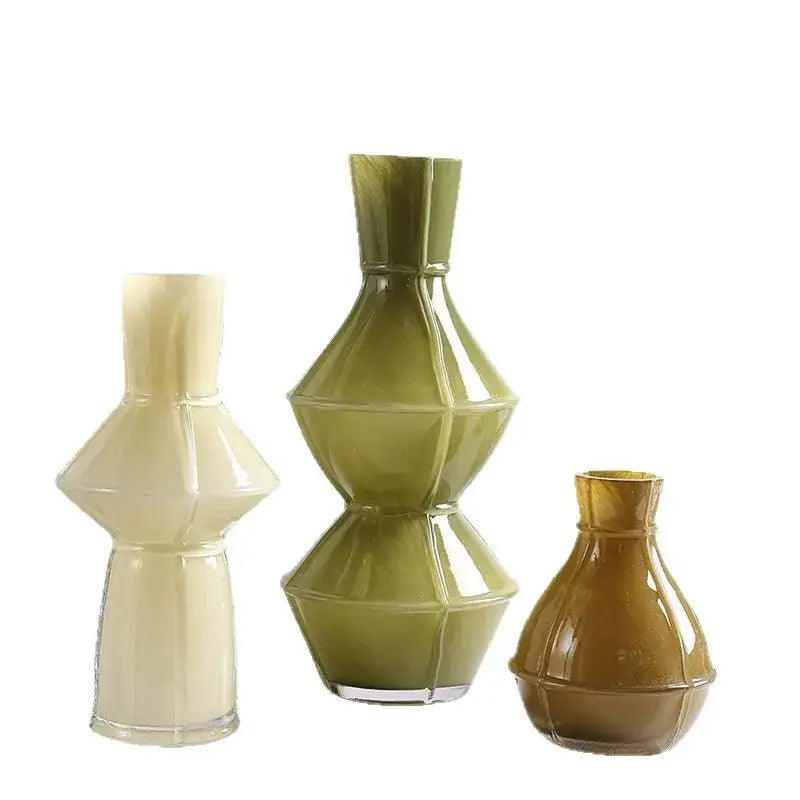 Three colorful geometric glass vases in cream olive green and amber hues with faceted designs for living room decorbites decor