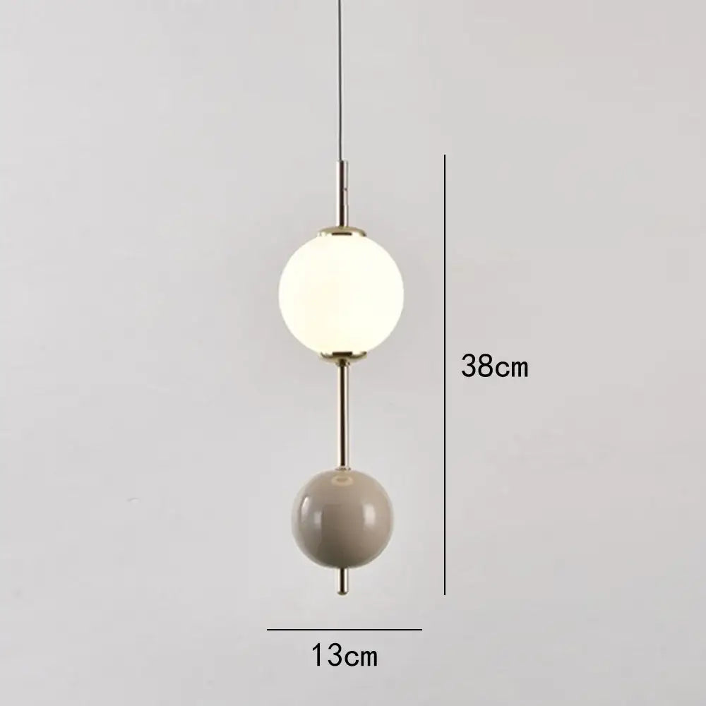 Modern colorful glass ball led pendant light with frosted white and matte beige orbs on brass rod for dining room decorbites