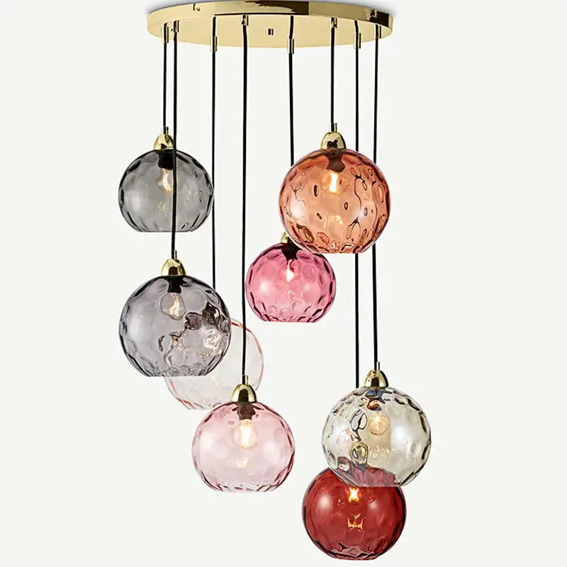 A modern pendant lights chandelier with seven colorful decorbites glass ball lustres in pink red gray and clear hues