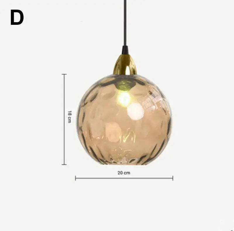 A spherical amber decorbites glass ball lustre pendant light with textured surface and gold-toned fixture for kitchens