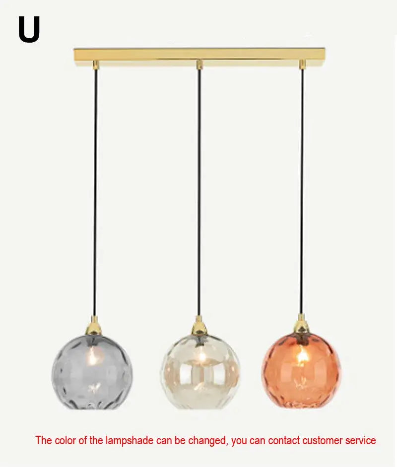 Gold-toned pendant lights with gray clear and amber glass ball lustre shades for modern kitchen decorbites lighting