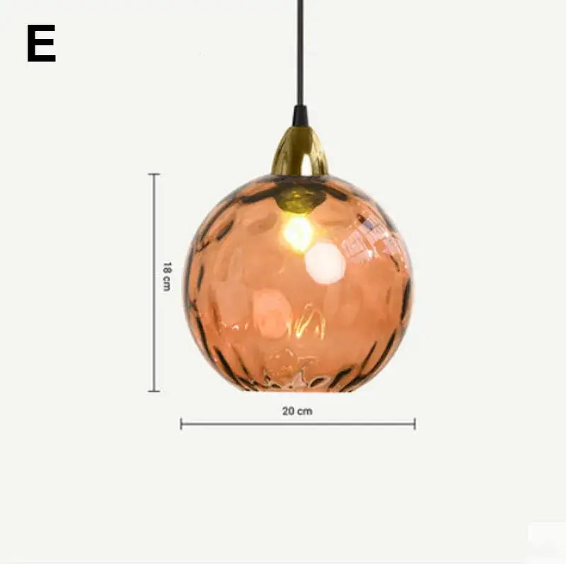 A warm amber glass ball lustre pendant light with hammered texture and brass fixture for kitchen decorbites pendant lights
